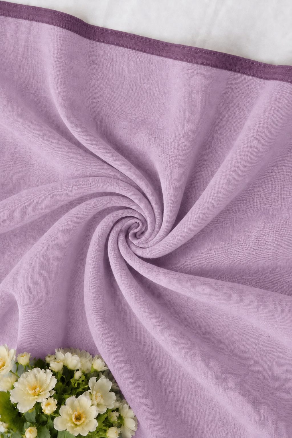 Soft lavender cotton blouse fabric with a contrast purple border, styled in a spiral drape.