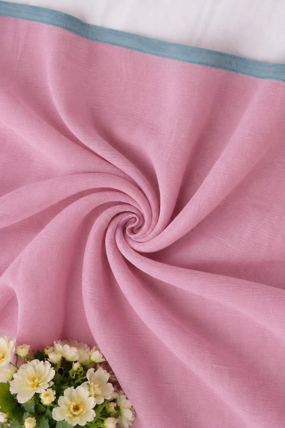 Soft pink cotton blouse fabric styled in a spiral drape.