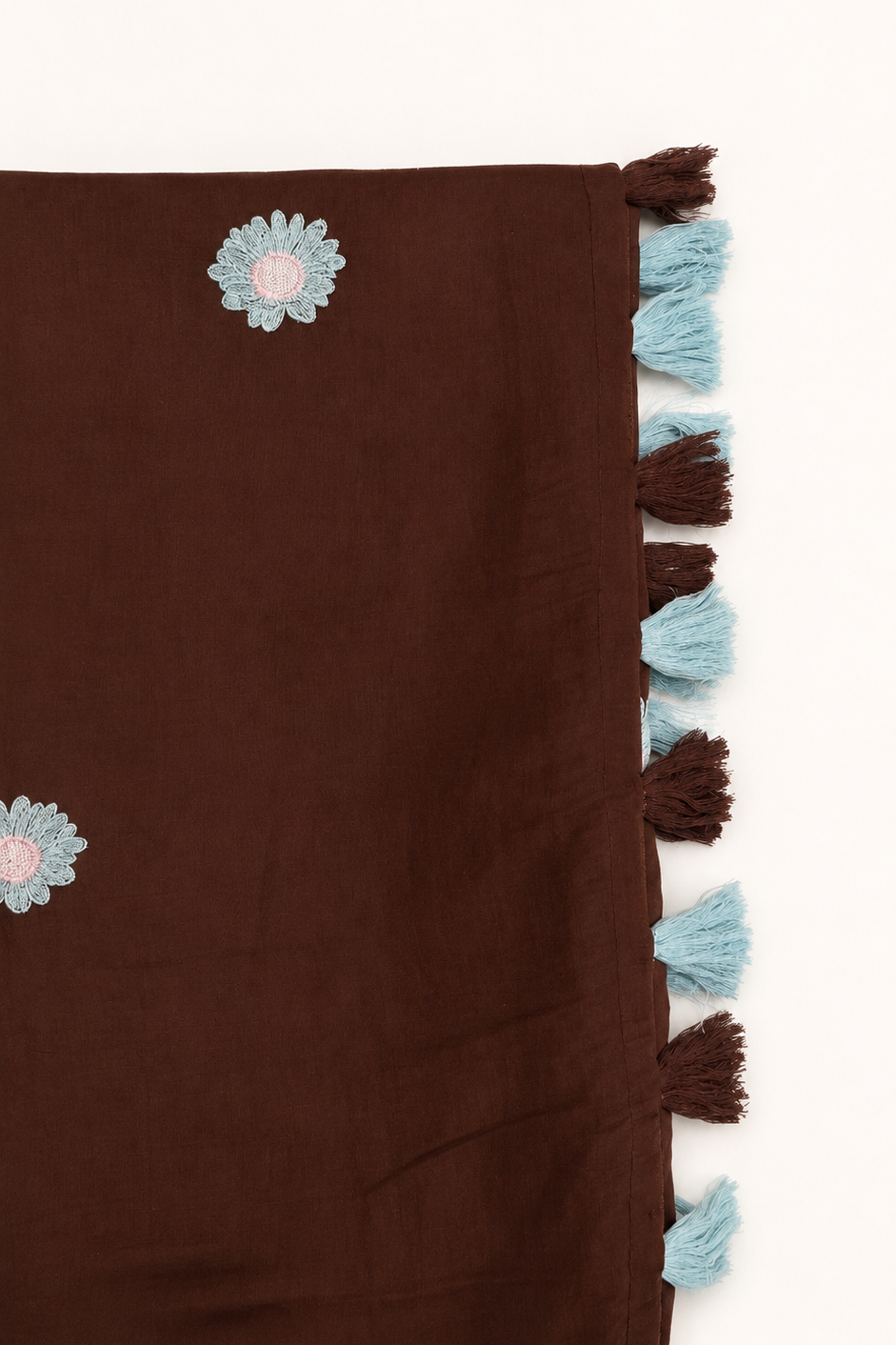 A dark brown scarf with light blue and pink embroidered flowers and a matching dark brown and light blue tassel border, shown on a plain white background.